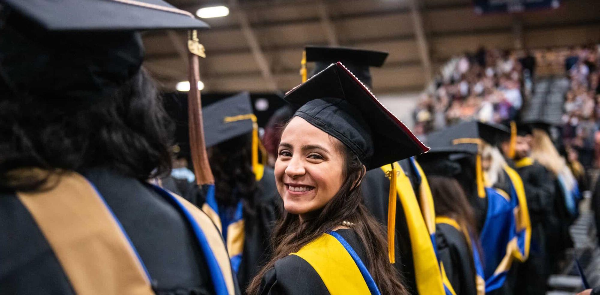 A latin female smiling while at her graduating ceremony
